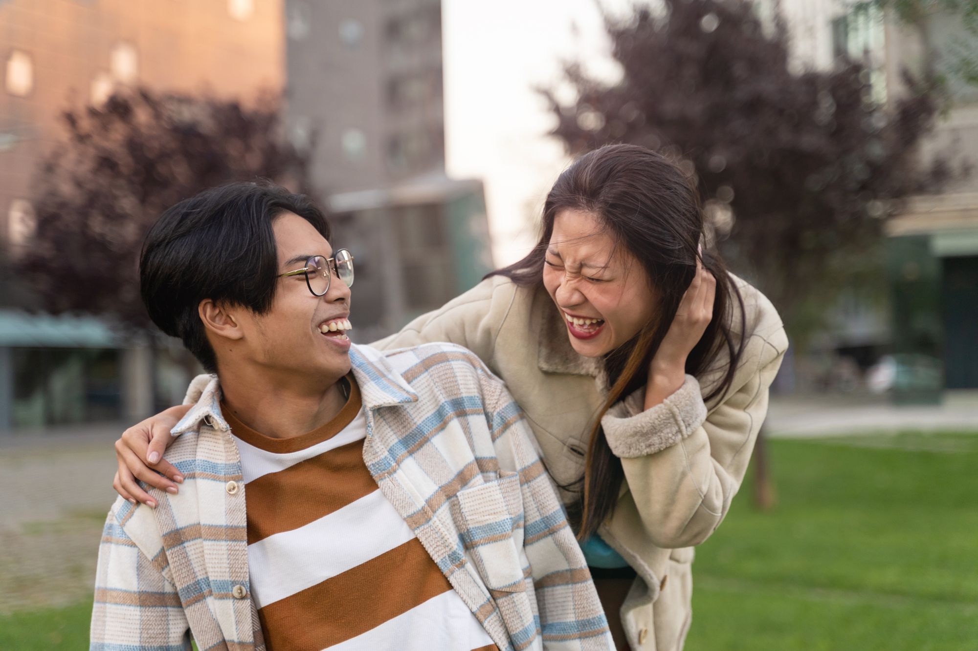 Two close friends laughing together