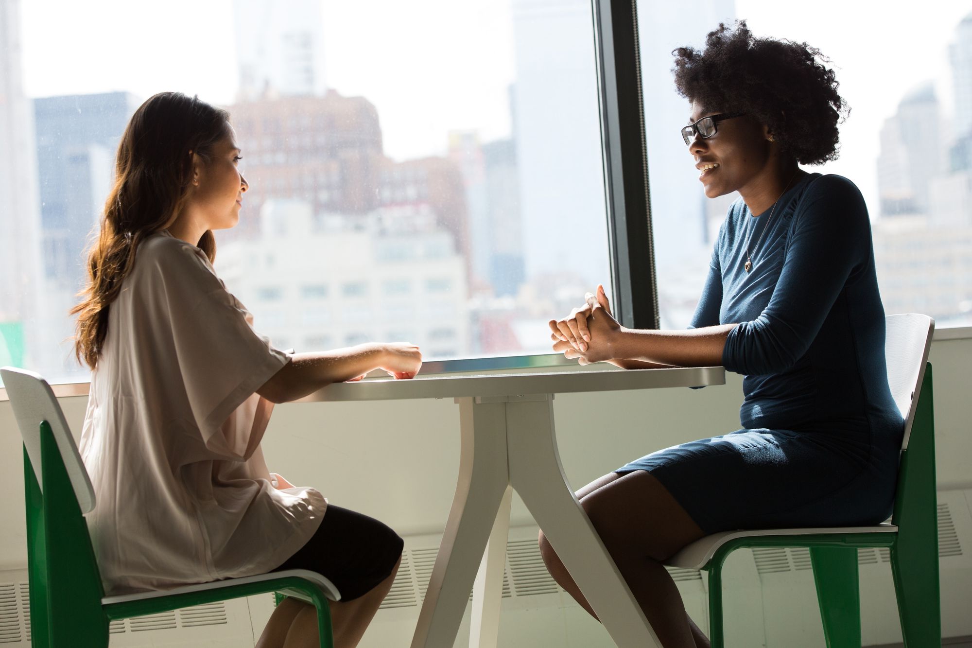 two women talking over a table