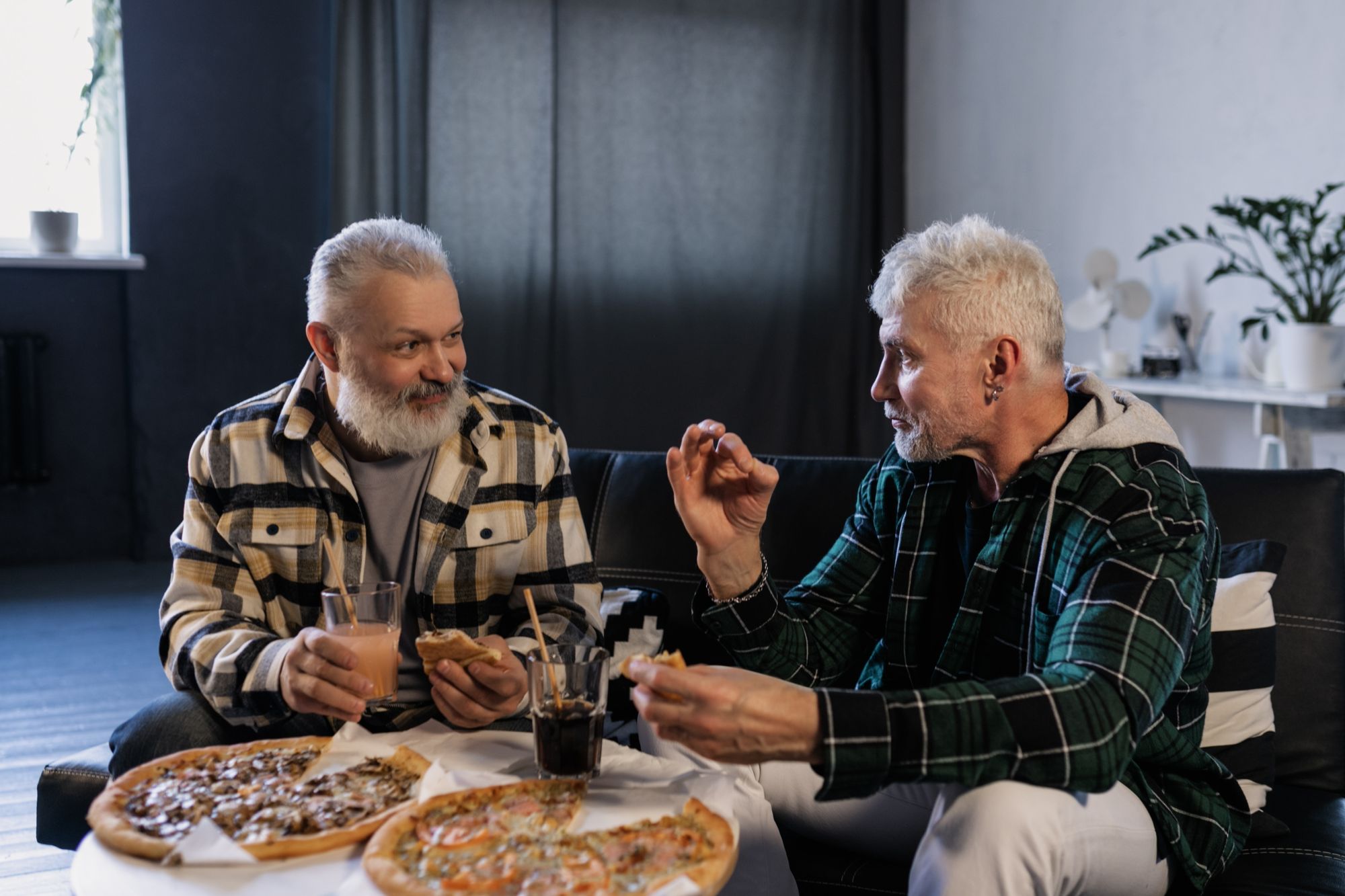 two men eating pizza