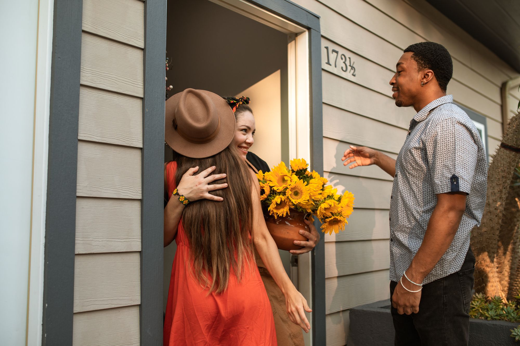 two people being ivited into a home