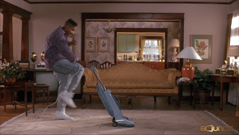 Guy cleaning the house with a vacuum cleaner