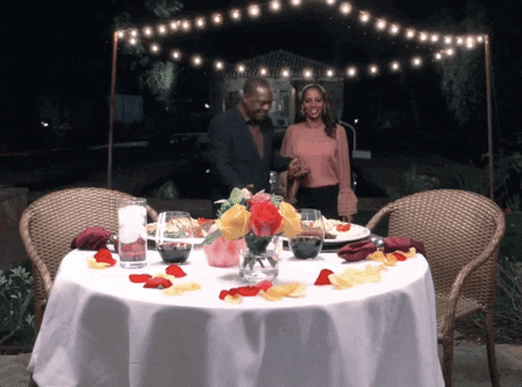 Man inviting a lady to the dinner table